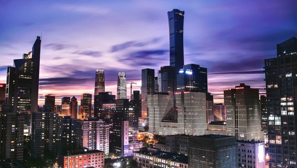 Tall, brightly-lit buildings reach into the sky in Beijing, China