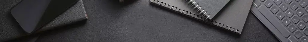 News blog banner image of notebooks and keyboard